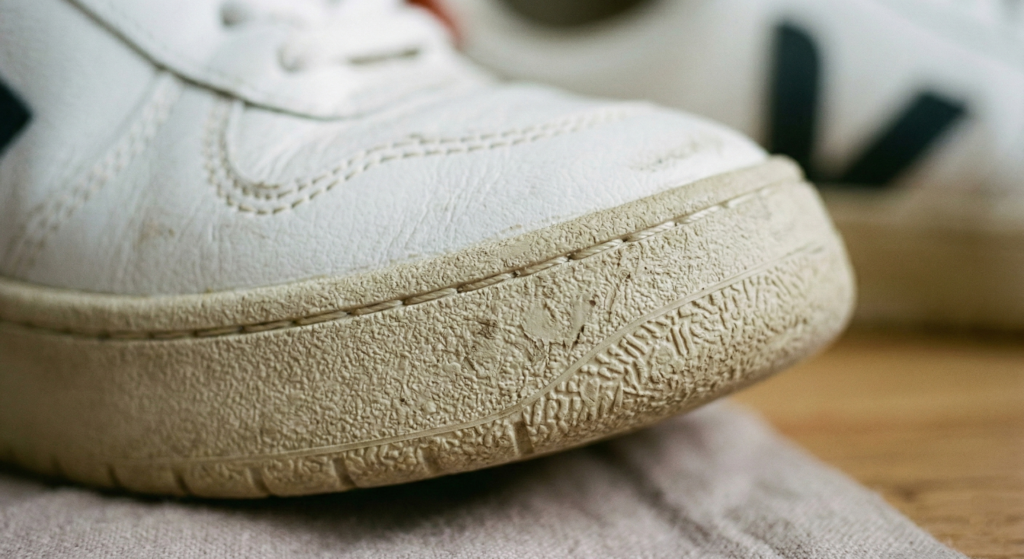Macro texture shot of a VEJA Amazonian rubber sole showing the dense, non-foam material and off-white recycled finish.