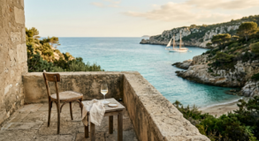 Code : alt="Stone terrace overlooking a secluded French islands bay with a sailboat anchored in turquoise waters