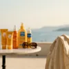 Selection of French pharmacy sunscreens including La Roche-Posay, Bioderma, and Avène on a table overlooking the Mediterranean sea