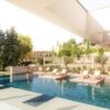 Luxury outdoor infinity pool with floating sun loungers at the Couvent des Minimes Spa in Provence