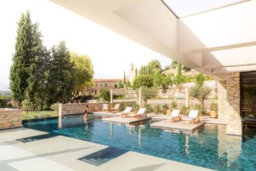 Luxury outdoor infinity pool with floating sun loungers at the Couvent des Minimes Spa in Provence