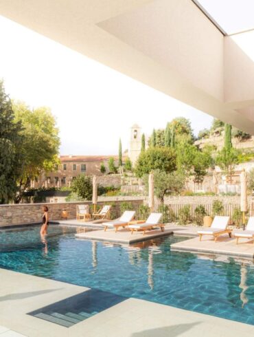 Luxury outdoor infinity pool with floating sun loungers at the Couvent des Minimes Spa in Provence
