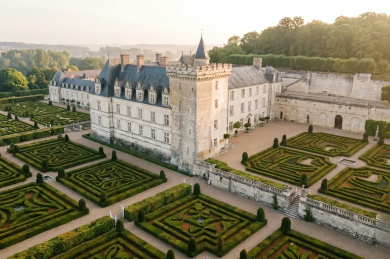 High-angle view of the symmetrical Renaissance gardens at Chateau de Villandry during golden sunrise