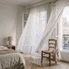 A serene bedroom in Paris with a linen tote bag, evoking a quiet luxury travel mood.