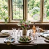 A rustic dining table set with mismatched crystal and sun-bleached linen